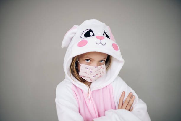 istock girl dressed as easter bunny rabbit with face mask 1217355668