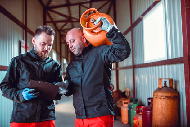 istock Two Males In Gas Store Working According To Clipboard Schedule 1217356454