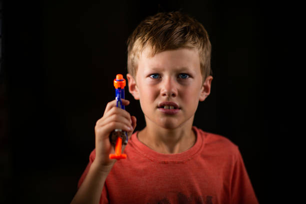 Boy with a toy gun portrait