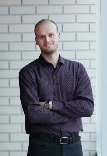 istock friendly man standing in the corridor of the office 1217359511
