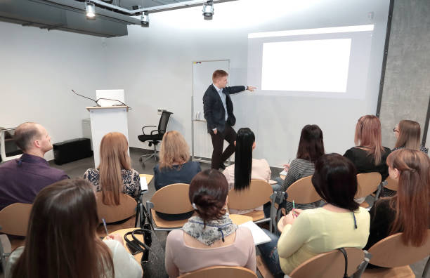 istock Speaker standing and lecturing on business conference in meeting hall 1217359567
