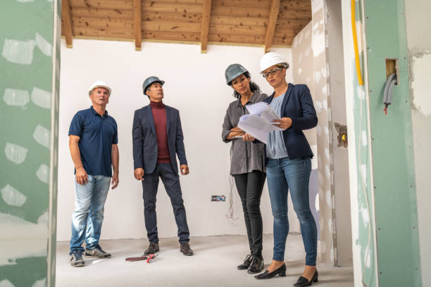 istock Architects and interior designers looking around in a house under construction 1217362972