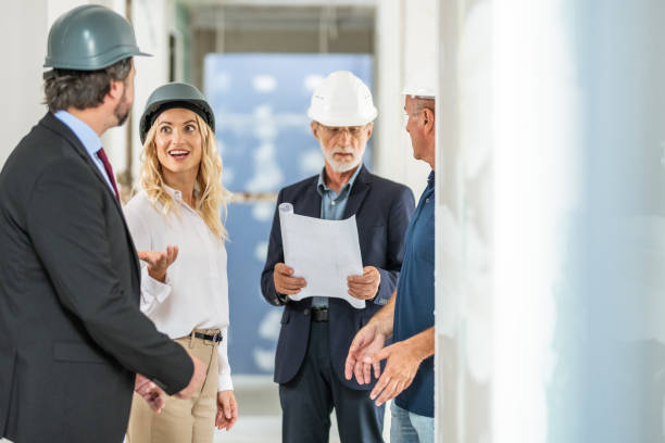 istock Architects and interior designer talking to investors on a construction site 1217362989