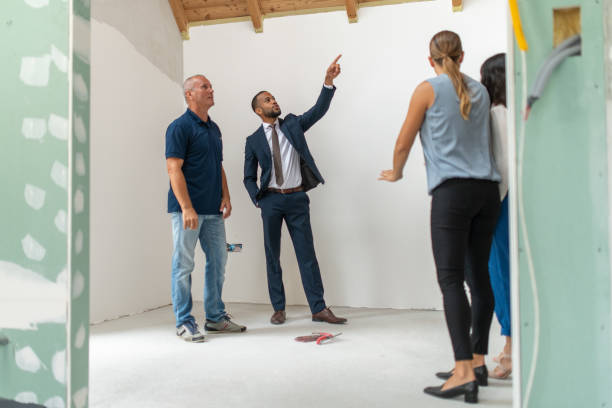istock Real-estate investor talking with experts in house under construction 1217362991