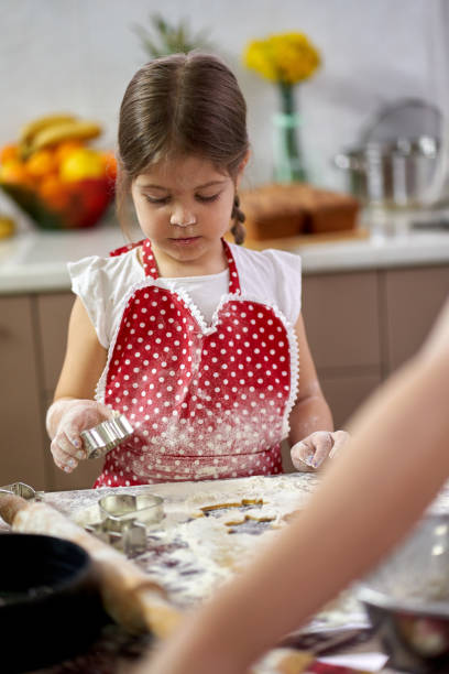 istock Girl making gingerbread cookies 1217363167