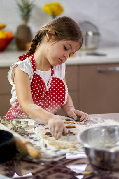 istock Girl making gingerbread cookies 1217363197