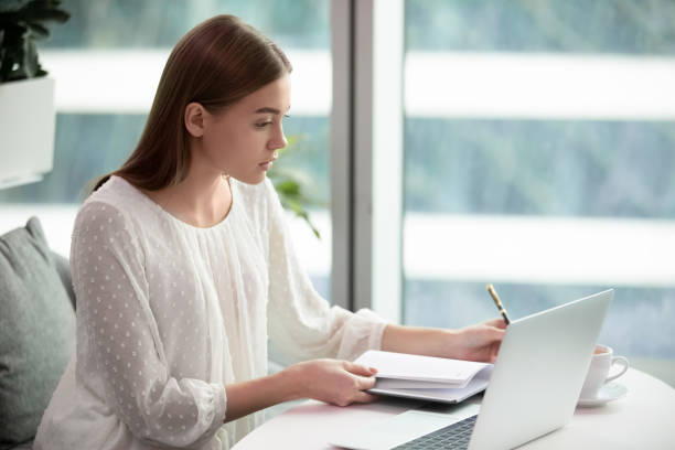 istock Concentrated female employee busy working on laptop 1217363238