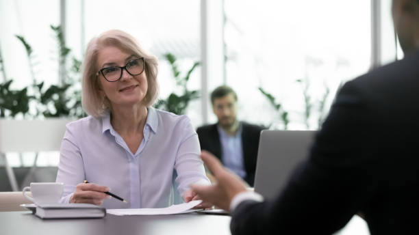istock Smiling senior businesswoman lead interview with candidate 1217363307