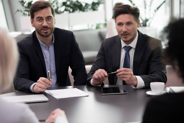 istock Motivated businesspeople talk discuss financial document together 1217363336