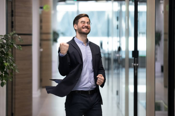 istock Happy young employee dancing in office celebrating success 1217363356