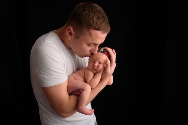 istock Father holds his newborn daughter 1217363501