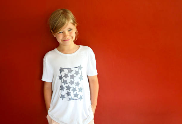istock Pretty emothional child on a red background. Copy space, daylight 1217366022