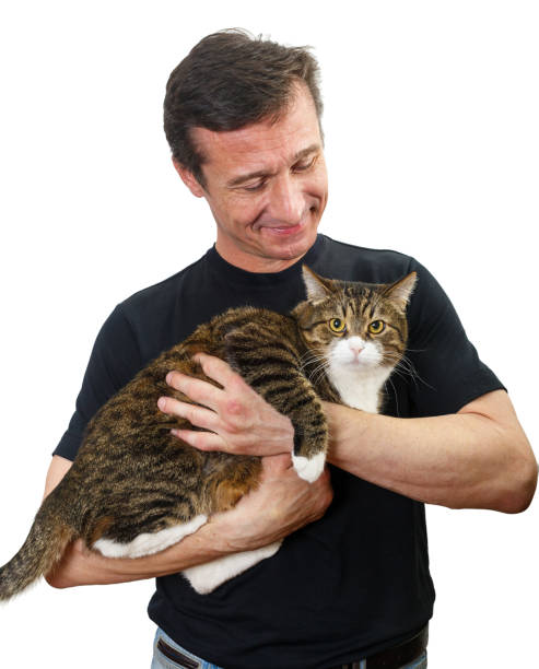 istock Mature man holds a grey cat in his arms 1217366514