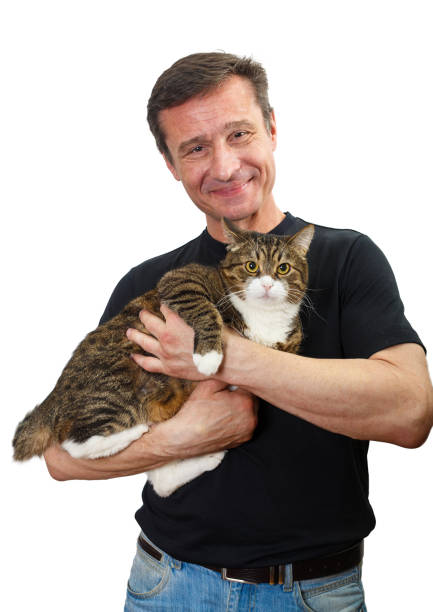 istock Mature man holds a grey cat in his arms 1217366634