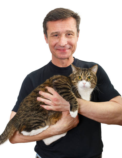 istock Mature man holds a grey cat in his arms 1217366747