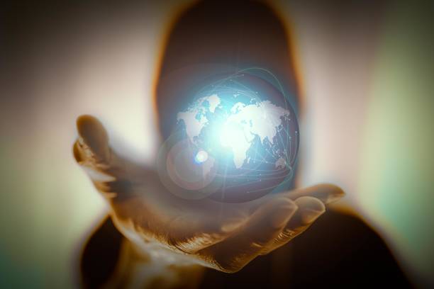 istock hands holding World over the Network connection of World map. 1217367894