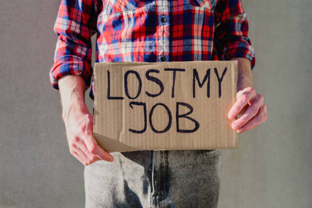 istock Man with cardboard sign LOST JOB 1217368048