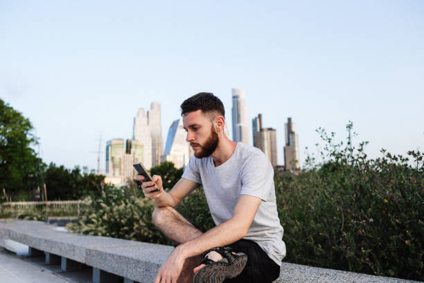 istock Young man using smartphone near the business center 1217368432