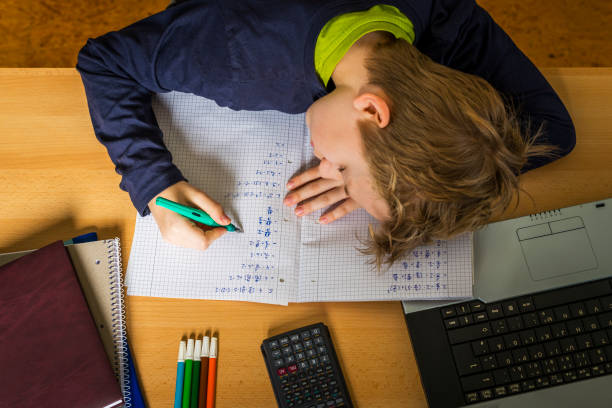 istock frustrated teenager doing homework 1217368756