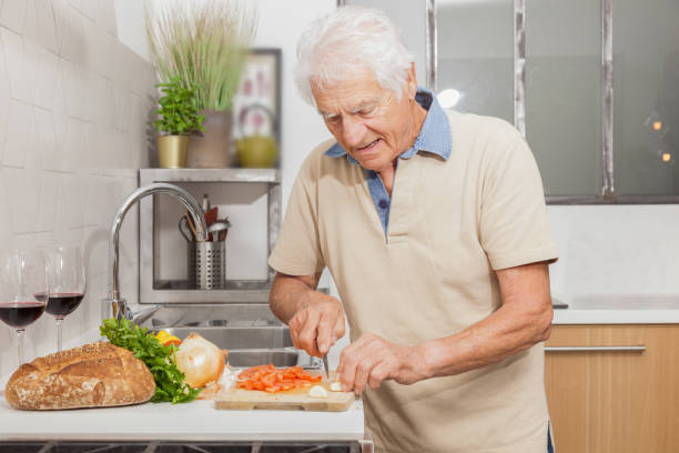 istock Senior man in a kitchen at home. 1217369990