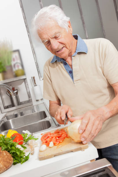 istock Senior man in a kitchen at home. 1217370029