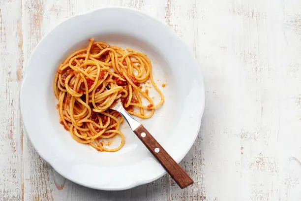 Spaghetti Bolognese on white wooden background