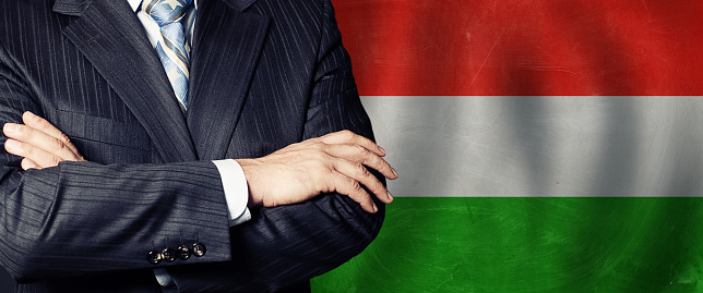 Male hands against Hungarian flag background, business, politics and education in Hungary