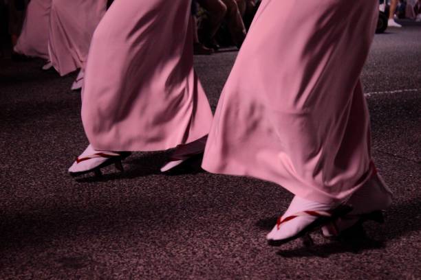 Awa Dance Festival Night shots of women performing a traditional dance in colorful kimonos and straw hats in Tokyo. japan women human foot japanese culture stock pictures, royalty-free photos & images