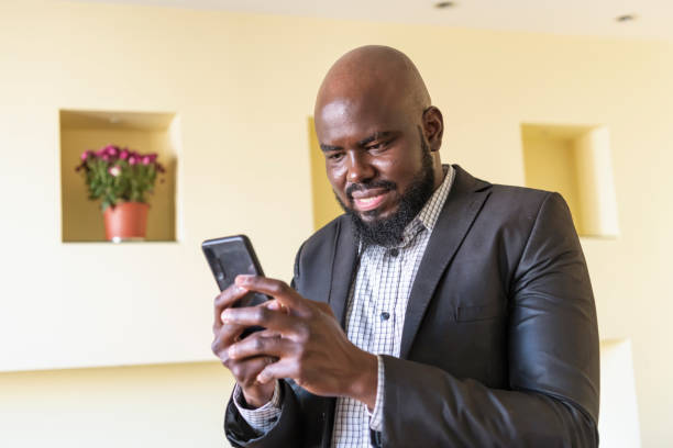 istock Self-Confident African Businessman at Home Using a Mobile Phone 1217375526