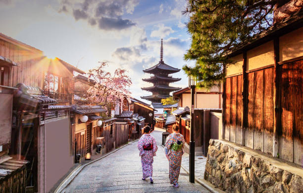 Yasaka Pagoda Kyoto, Japan Kyoto - Japan - April 9, 2017:Yasaka Pagoda and Sannen Zaka Street, Kyoto, Japan. Tourists wander down the narrow streets of the Higashiyama District neighbourhood in Kyoto, Japan buddhist house of worship stock pictures, royalty-free photos & images