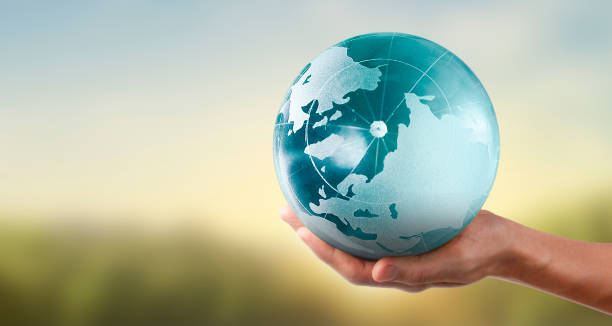 istock Globe , earth in human hand, holding our planet glowing.  image provided by Nasa 1217377831