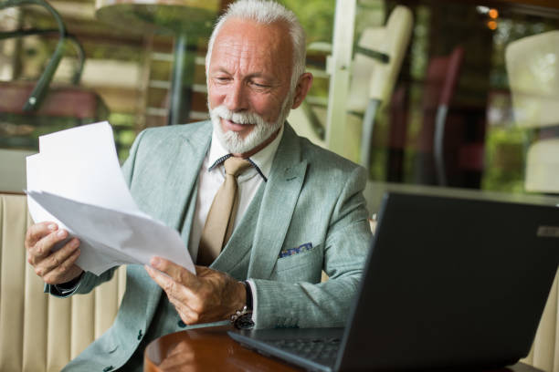 istock Senior businessman working in cafe 1217378369