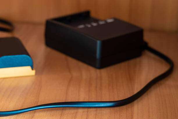 istock camera battery charger and cord soft focus elementary technology equipment photographers must have on wooden surface cell in domestic cupboard 1217379926