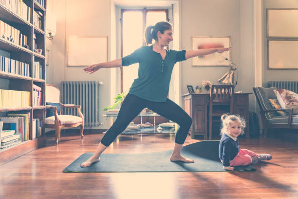istock mom and daughter at home having a zumba session 1217382630