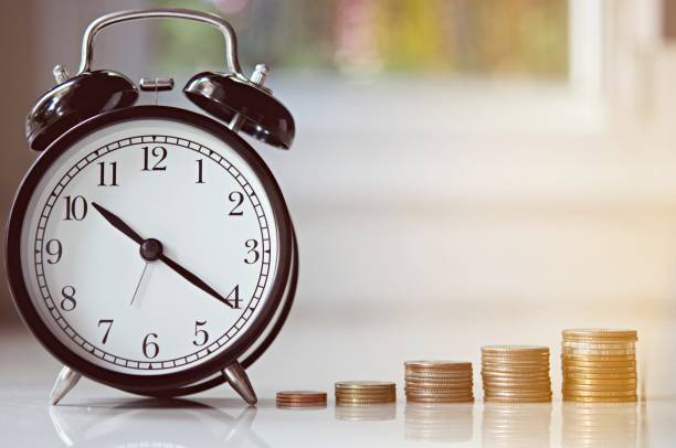 istock vintage alarm clock show before 8 o'clock on the table with green leafs blurred background 1217384435