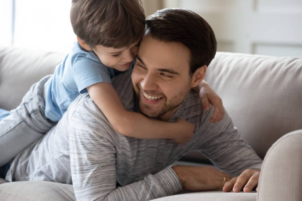 istock Preschooler boy relax at home with young dad 1217386149
