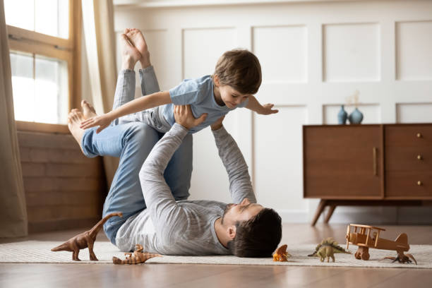 istock Young father playing at home with preschooler son 1217386176