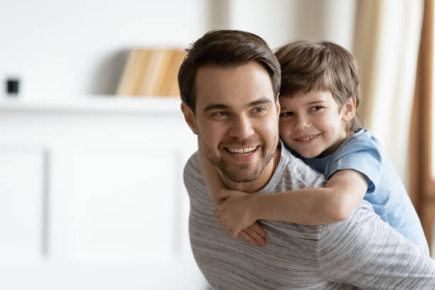 istock Overjoyed little boy piggyback play with young dad 1217386274