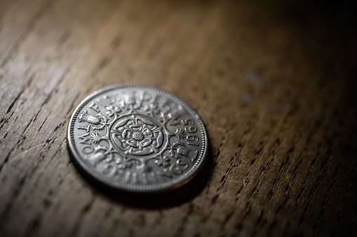 Old coins on antique wood table: Two shillings