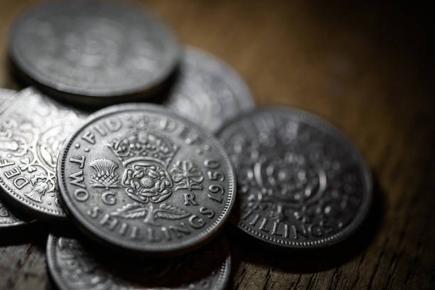 istock Old coins on antique wood table: Two shillings 1217388122