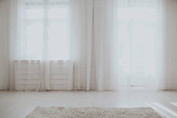 istock interior of an empty white room with windows 1217388639