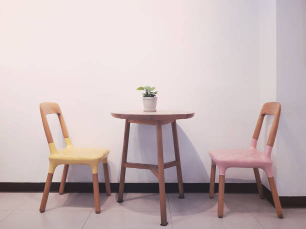 istock Retro two chairs and wooden tablewith flowerpot. 1217392625