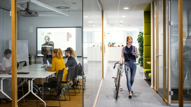 istock Businesswoman arriving to work with bicycle 1217393732