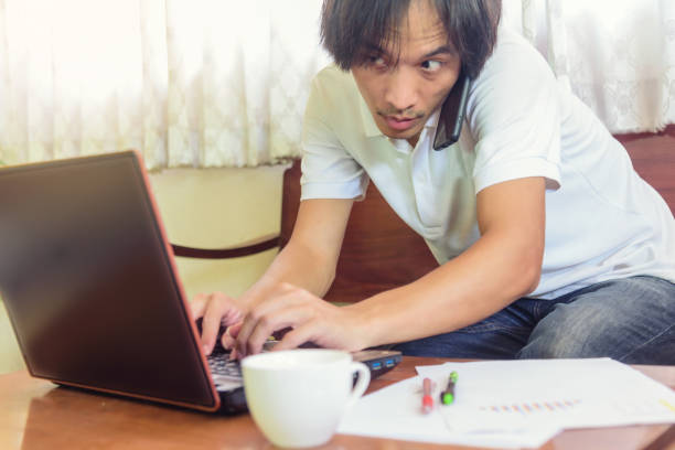 istock Work from home / The man use smartphone and laptop for co-working in working time 1217394057