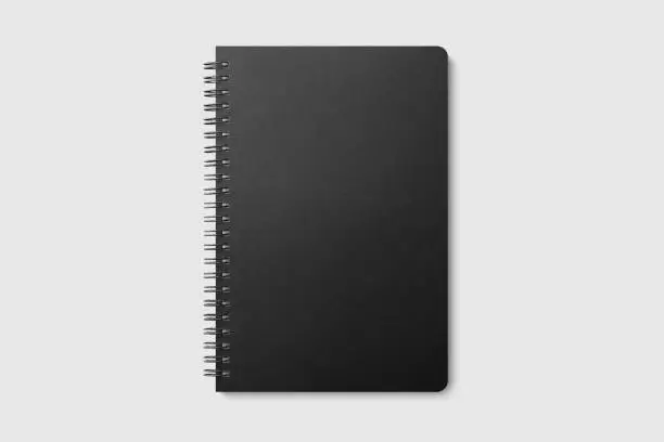 Photo of Real photo, spiral bound notepad mockup template with black paper cover, isolated on light grey background