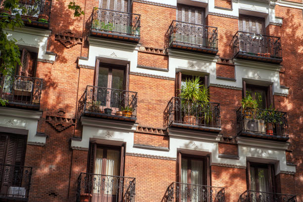 istock Looking up at red-brick building with decorative shuttered balconies 1217395673