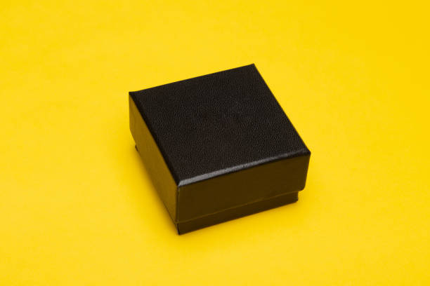 istock Mini black box product packaging isolated on yellow background 1217397978