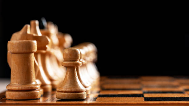 istock Vintage wooden chess board and figures 1217398300
