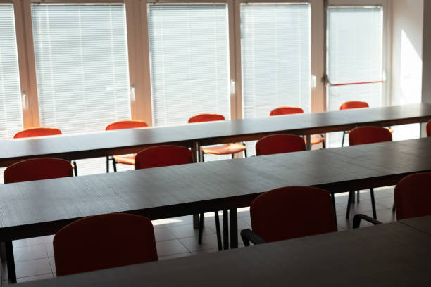 istock Empty desks and chairs in deserted office room 1217398447