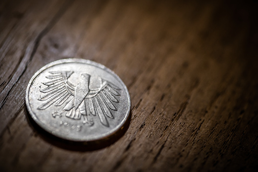 Old coins on antique wood table: German coin